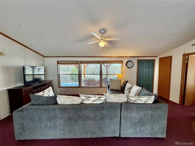 a living room with furniture and large windows