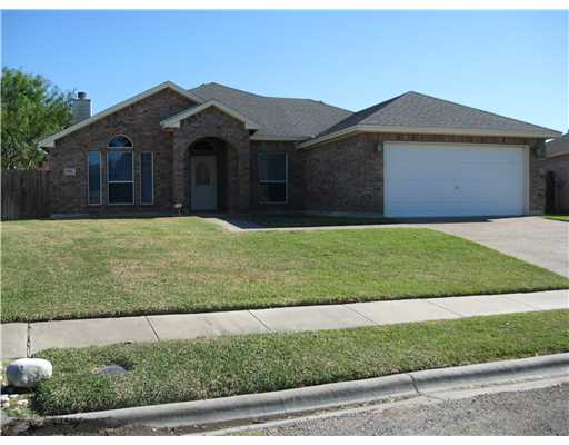 3162 Quail Springs Road Corpus Christi, TX 78414 - Photo 1 of 3 a front view of a house with a garden