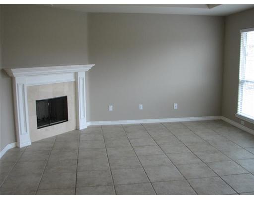 3162 Quail Springs Road Corpus Christi, TX 78414 - Photo 2 of 3 a view of an empty room with a fireplace and a window