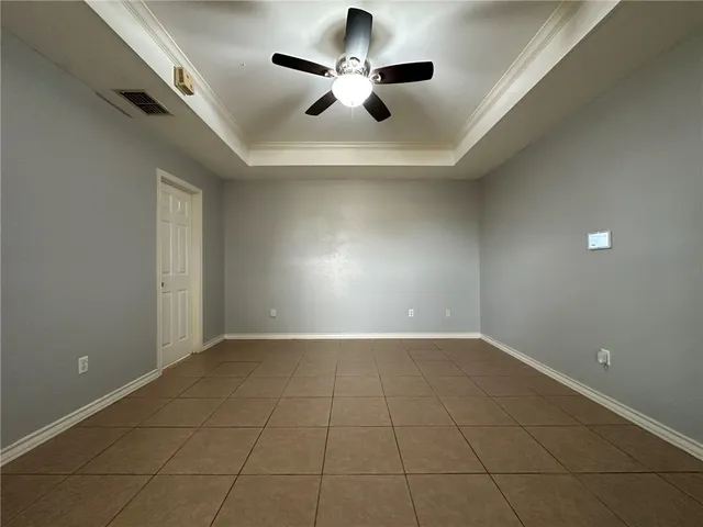 an empty room with projector and fan