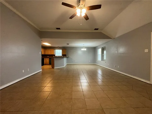 a view of a livingroom with a ceiling fan and window