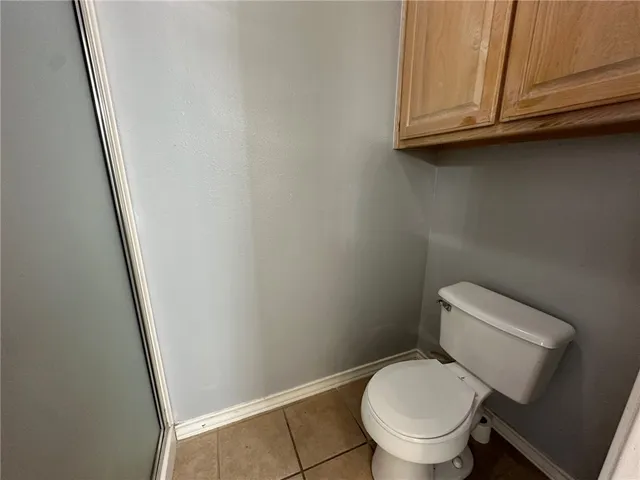 a white toilet sitting next to a sink