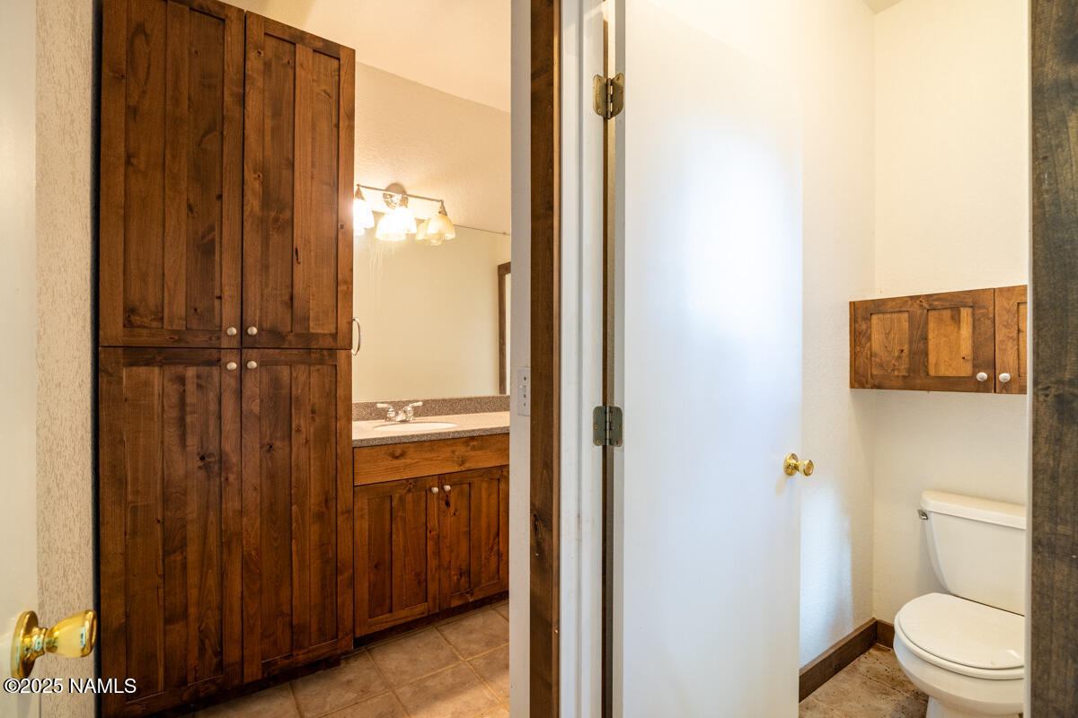 129 North Spitz Spring Road Parks, AZ 86018 - Photo 13 of 59 a bathroom with a granite countertop sink toilet and shower