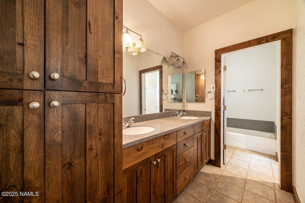 129 North Spitz Spring Road Parks, AZ 86018 - Photo 14 of 59 a bathroom with a granite countertop sink and a mirror