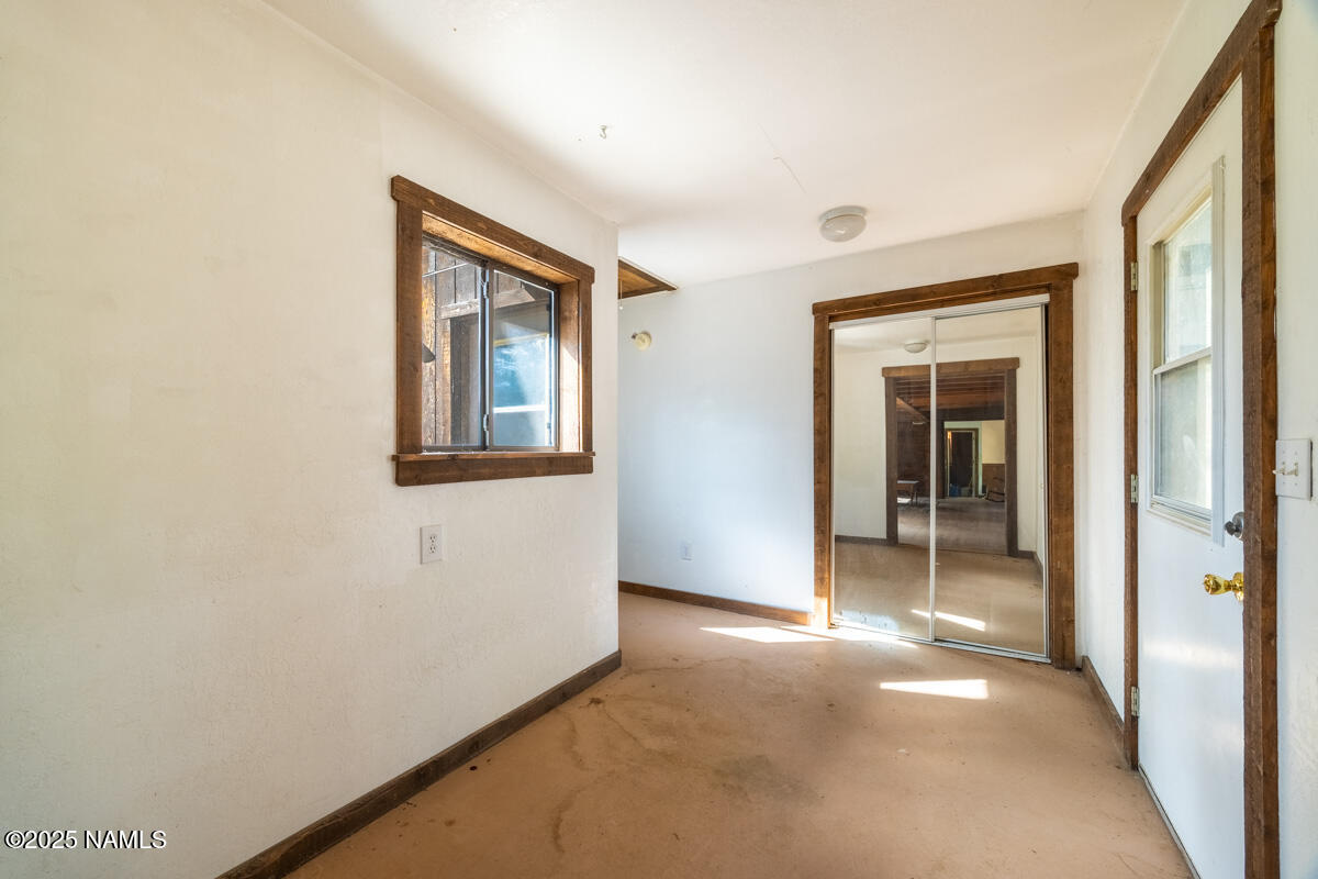 129 North Spitz Spring Road Parks, AZ 86018 - Photo 22 of 59 a view of a hallway with wooden floor and a bathroom