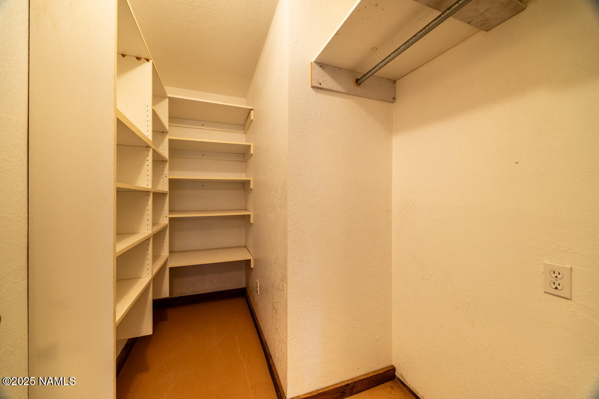 129 North Spitz Spring Road Parks, AZ 86018 - Photo 28 of 59 a view of walk in closet with empty racks