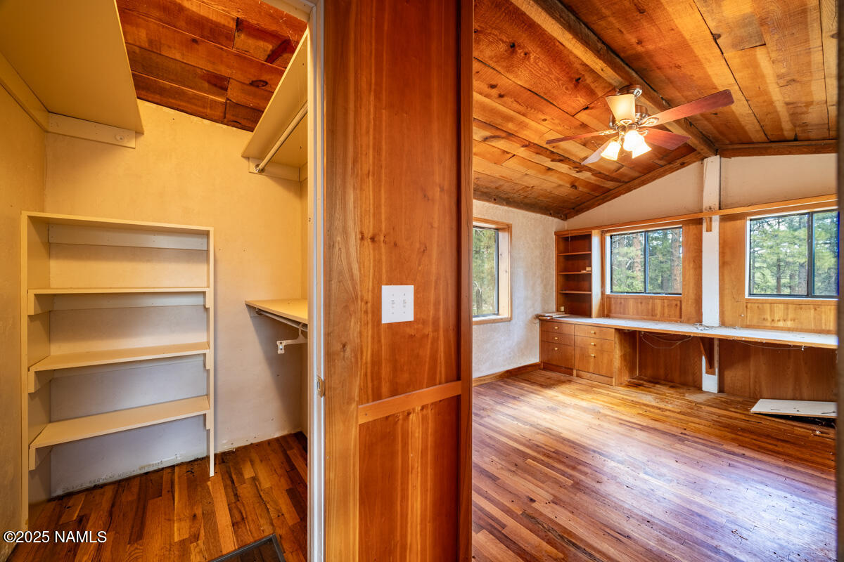 129 North Spitz Spring Road Parks, AZ 86018 - Photo 29 of 59 a view of walk in closet with window and wooden floor