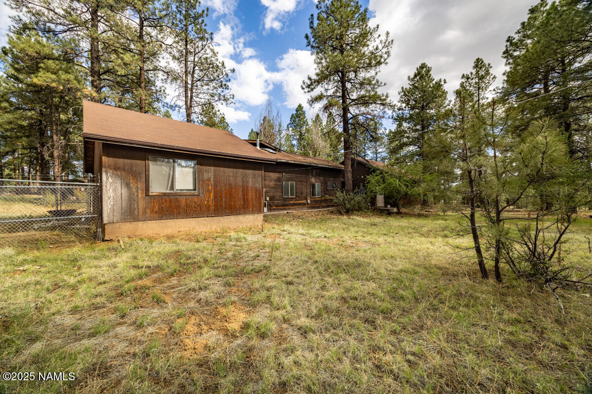 129 North Spitz Spring Road Parks, AZ 86018 - Photo 34 of 59 a house with trees in front of it