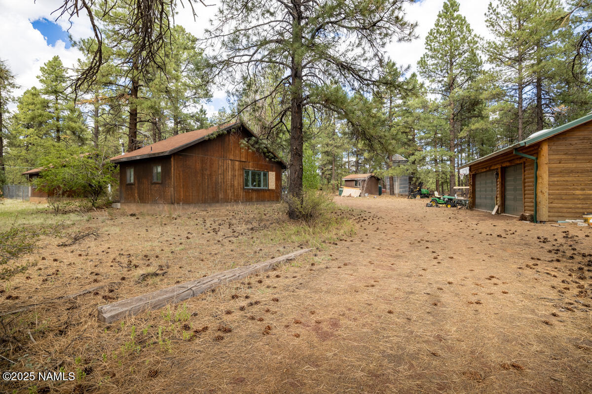 129 North Spitz Spring Road Parks, AZ 86018 - Photo 37 of 59 a front view of a house with a yard