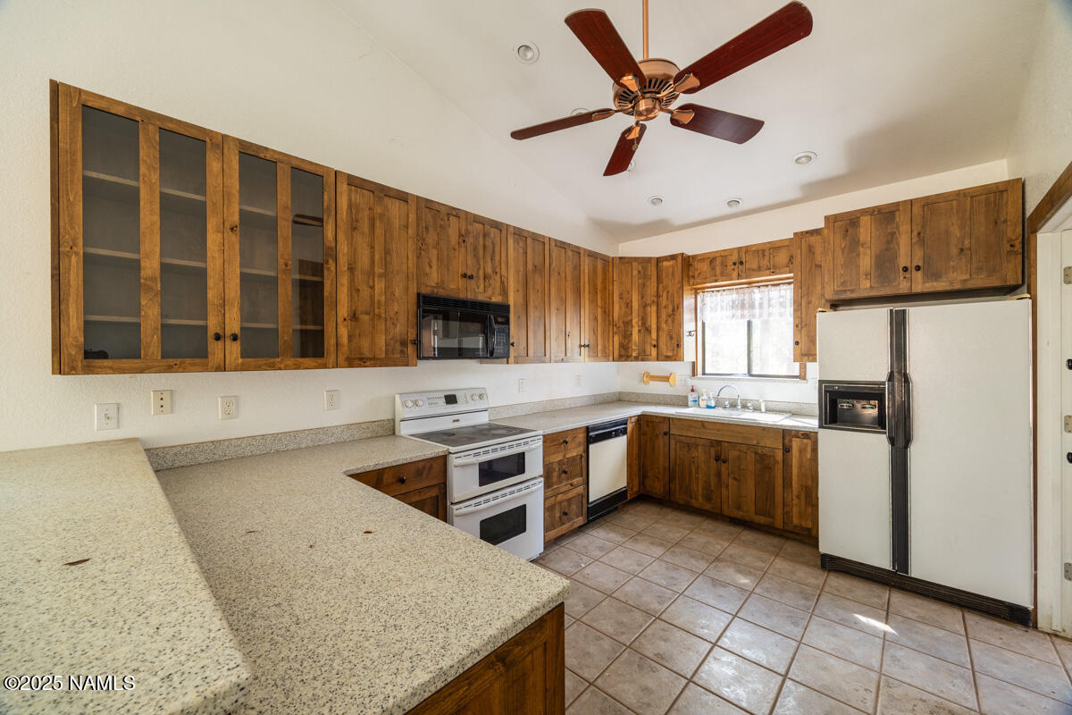 129 North Spitz Spring Road Parks, AZ 86018 - Photo 9 of 59 a kitchen with a stove a sink and a refrigerator