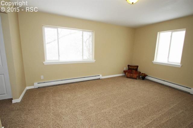 Large master suite with adjoining bath, his and hers closets, and dressing area between closets.