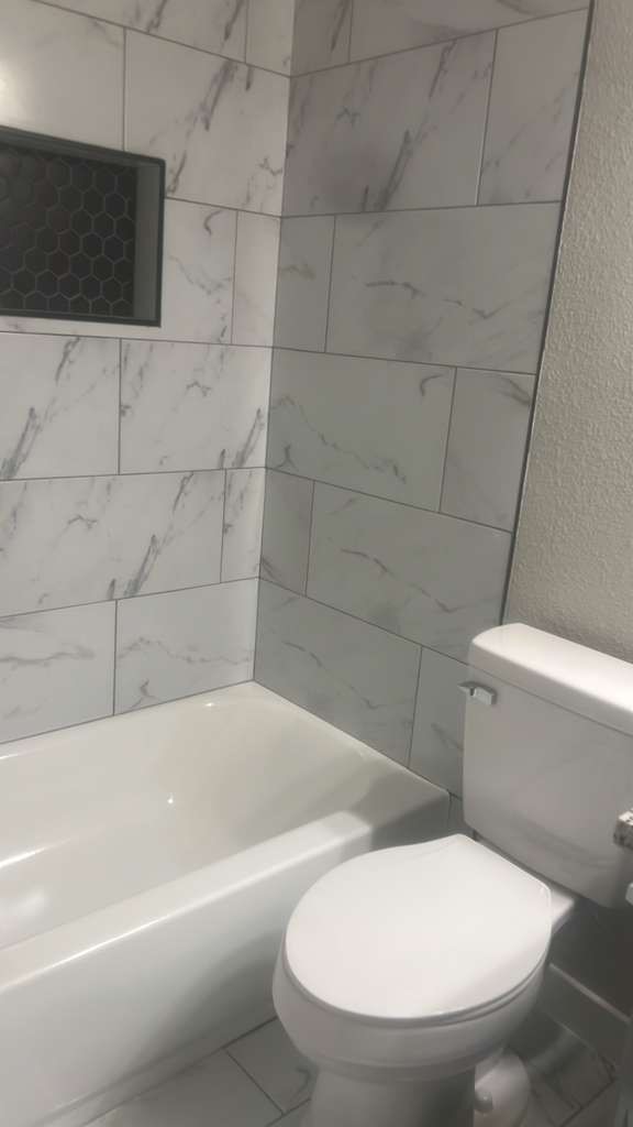 8617 Mapletwist Street Houston, TX 77083 - Photo 3 of 11 a bathroom with a toilet and bathtub