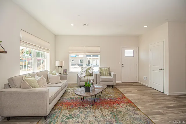 a living room with furniture a chandelier and a couch