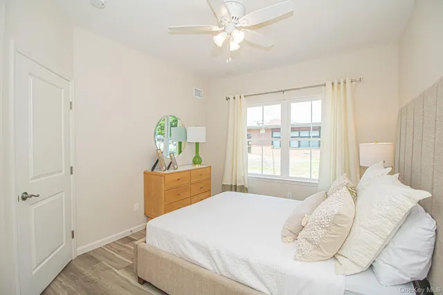a bedroom with a bed dresser and a window