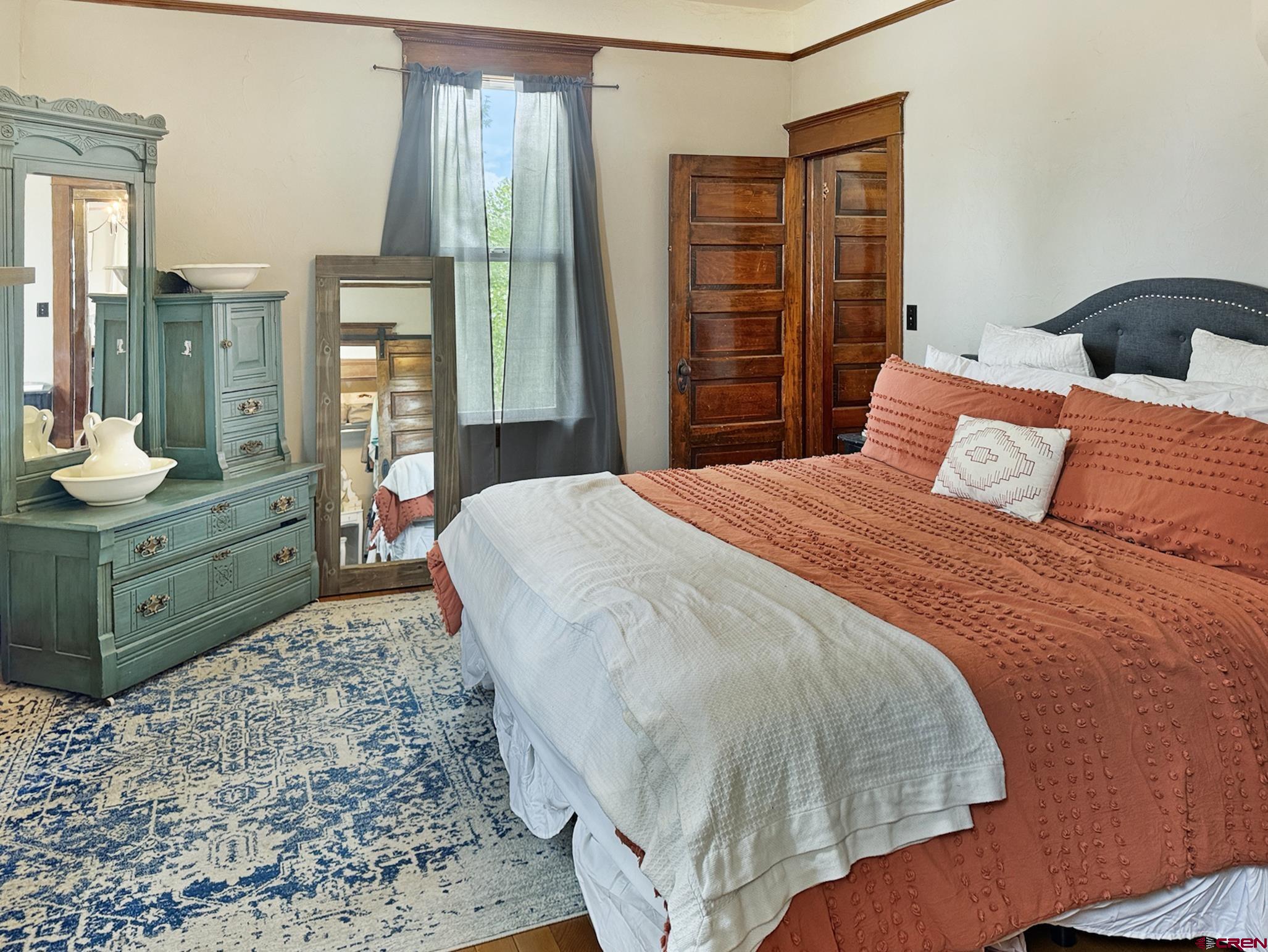 20570 Iris Road Austin, CO 81410 - Photo 11 of 35 a bedroom with a bed and large windows