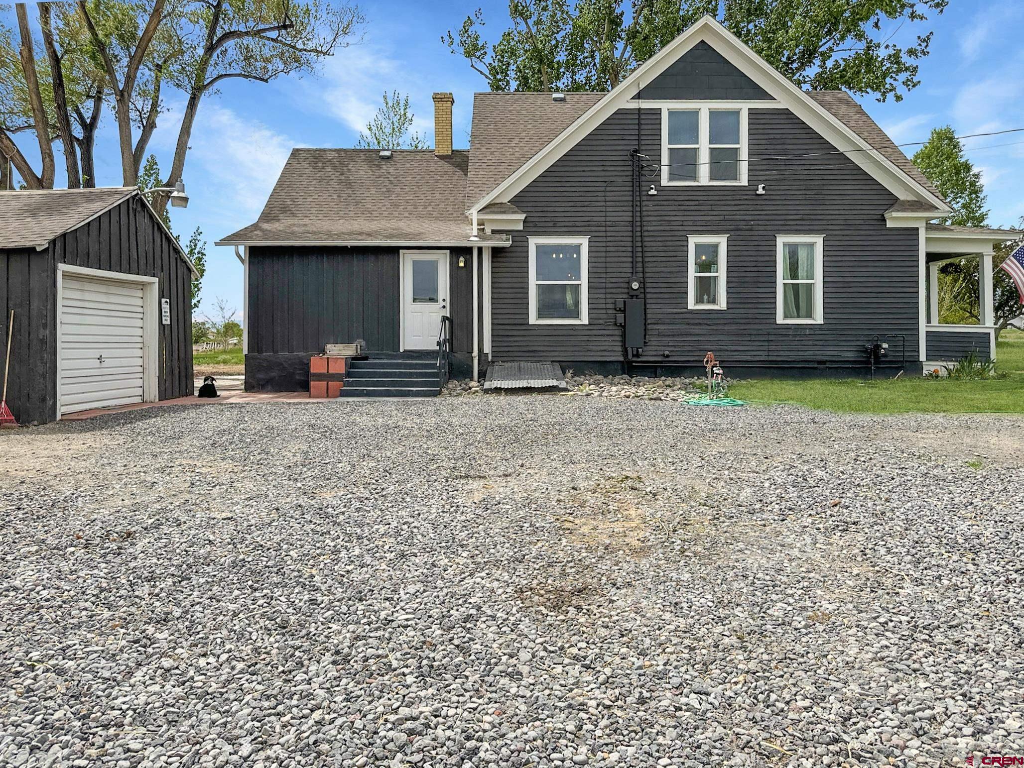 20570 Iris Road Austin, CO 81410 - Photo 24 of 35 a front view of a house with a garden and trees