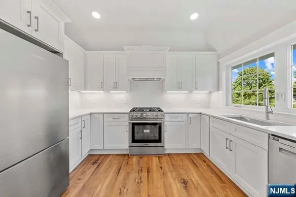 a kitchen with a sink stove and cabinets
