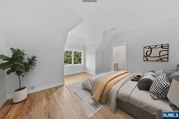 a bedroom with a bed and a potted plant