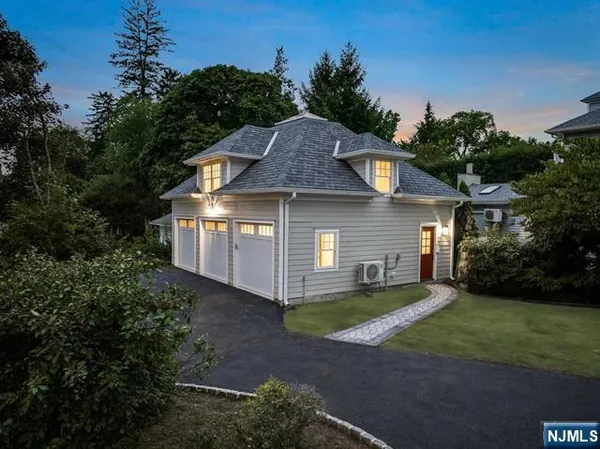 a view of a house with a big yard and large trees