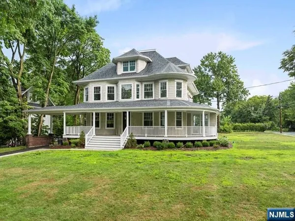 a front view of a house with a yard table and chairs