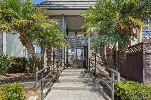 a front view of a house with a tree