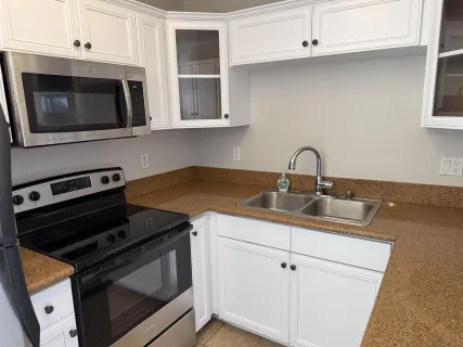 a kitchen with a stove and a microwave
