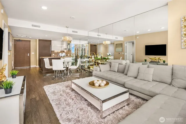 a living room with furniture a flat screen tv and a large window