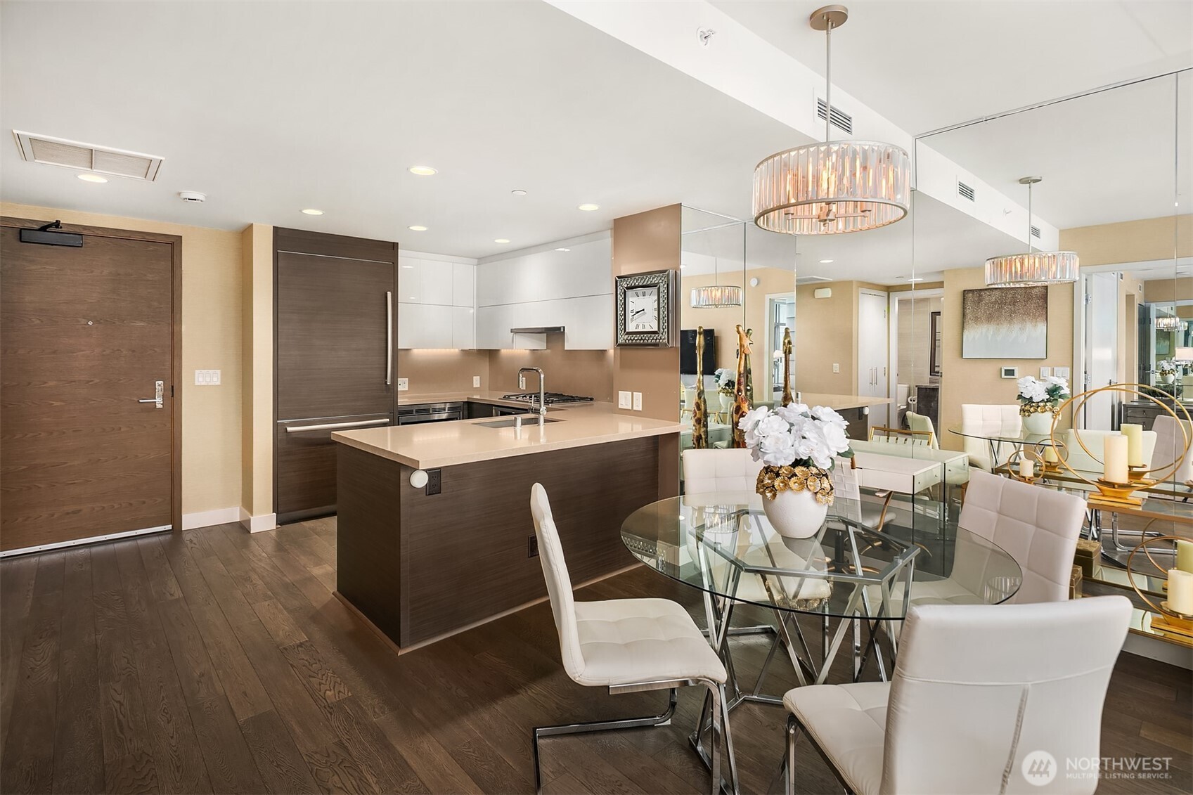 588 Bell Street, Unit 2405S Seattle, WA 98121 - Photo 6 of 34 a view of a dining room with furniture a kitchen and chandelier