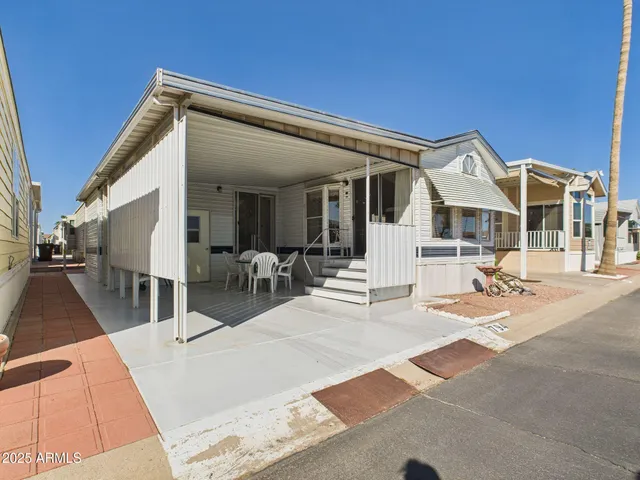a view of a patio with a table and chairs