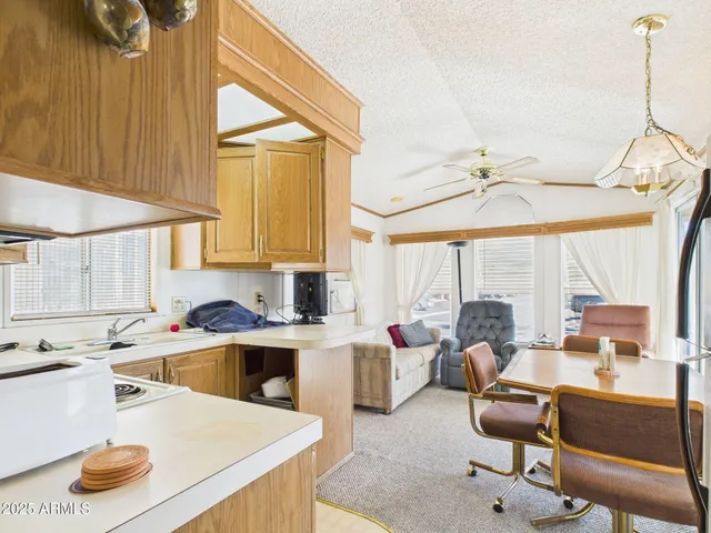 a kitchen with a table chairs and white cabinets