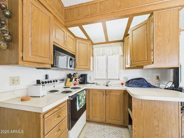 a kitchen with a sink a stove and cabinets
