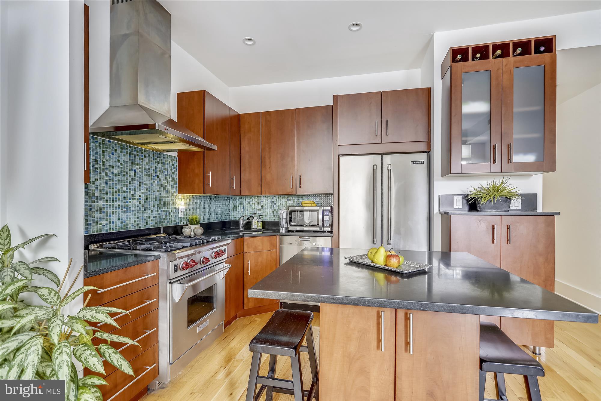 a kitchen with stainless steel appliances granite countertop a stove refrigerator sink and cabinets