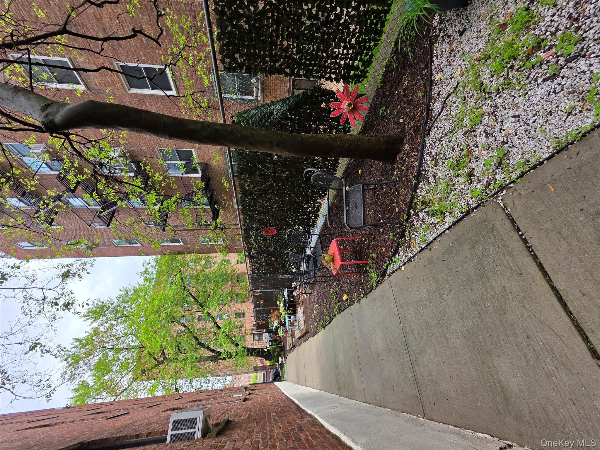 98-50 67th Avenue, Unit 1H Queens, NY 11374 - Photo 14 of 15 a view of a back yard of the house