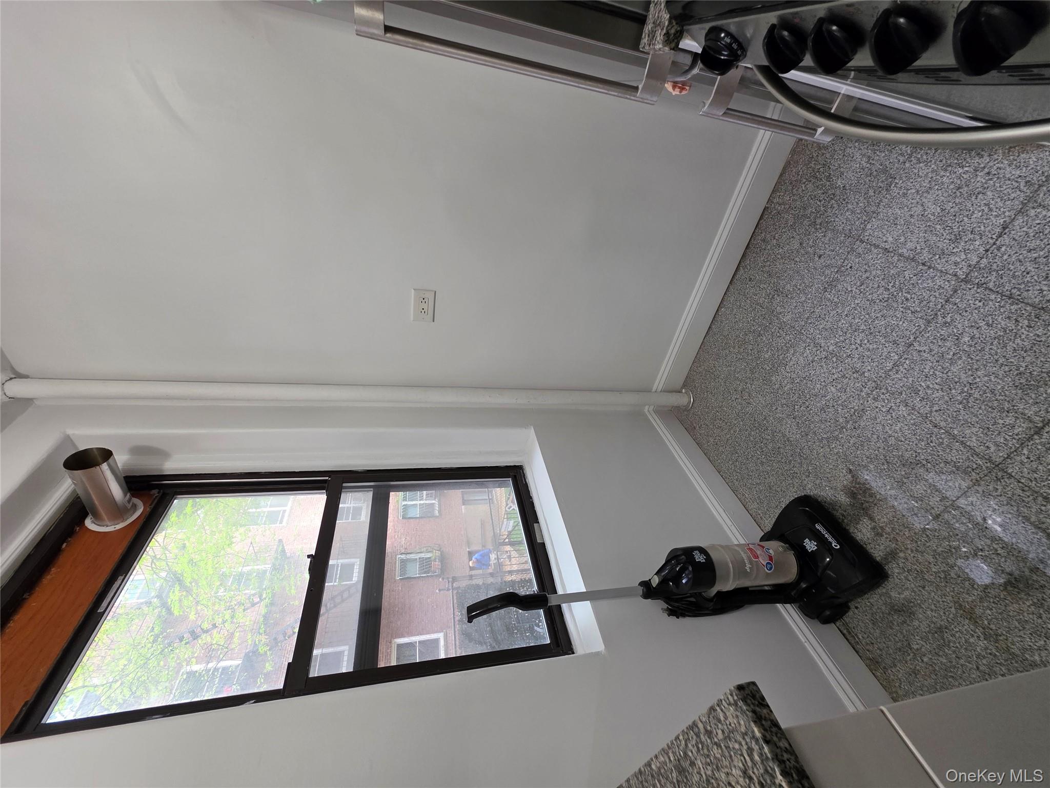 98-50 67th Avenue, Unit 1H Queens, NY 11374 - Photo 7 of 15 a view of room with a window and a bicycle