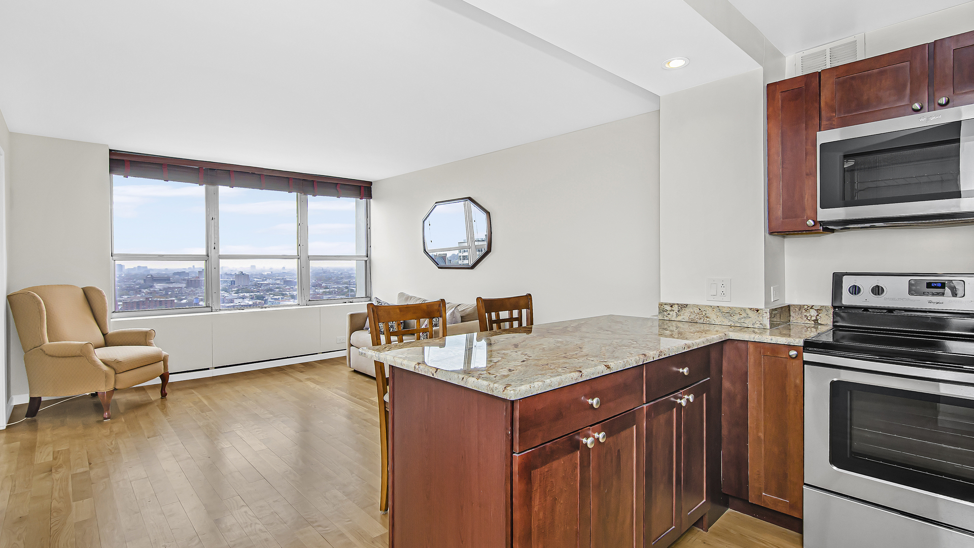 655 West Irving Park Road, Unit 2607 Chicago, IL 60613 - Photo 2 of 16 a kitchen with a stove a sink and a microwave