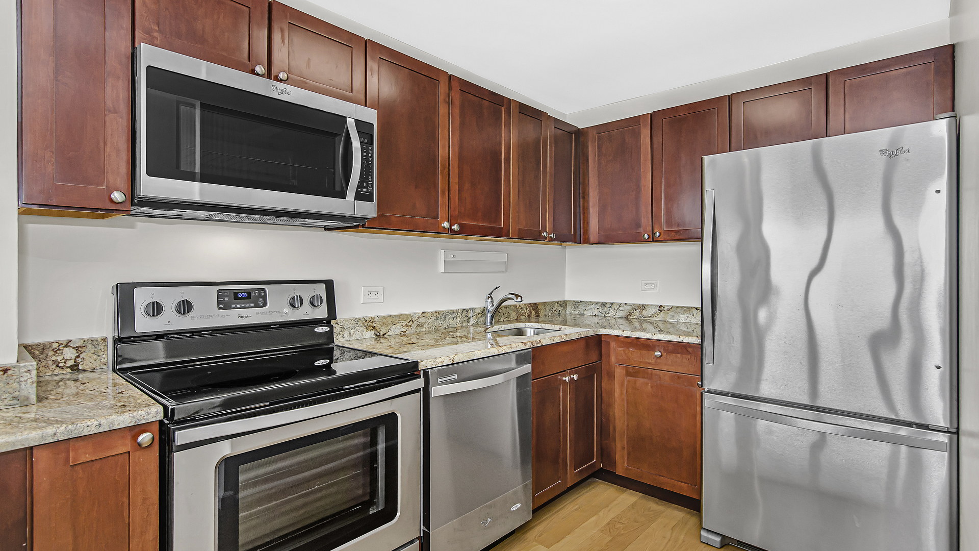 655 West Irving Park Road, Unit 2607 Chicago, IL 60613 - Photo 3 of 16 a kitchen with stainless steel appliances a stove microwave and refrigerator