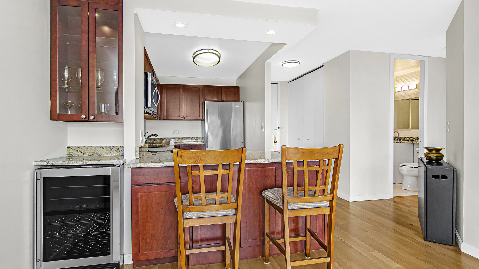 655 West Irving Park Road, Unit 2607 Chicago, IL 60613 - Photo 4 of 16 a view of kitchen island with furniture and wooden floor