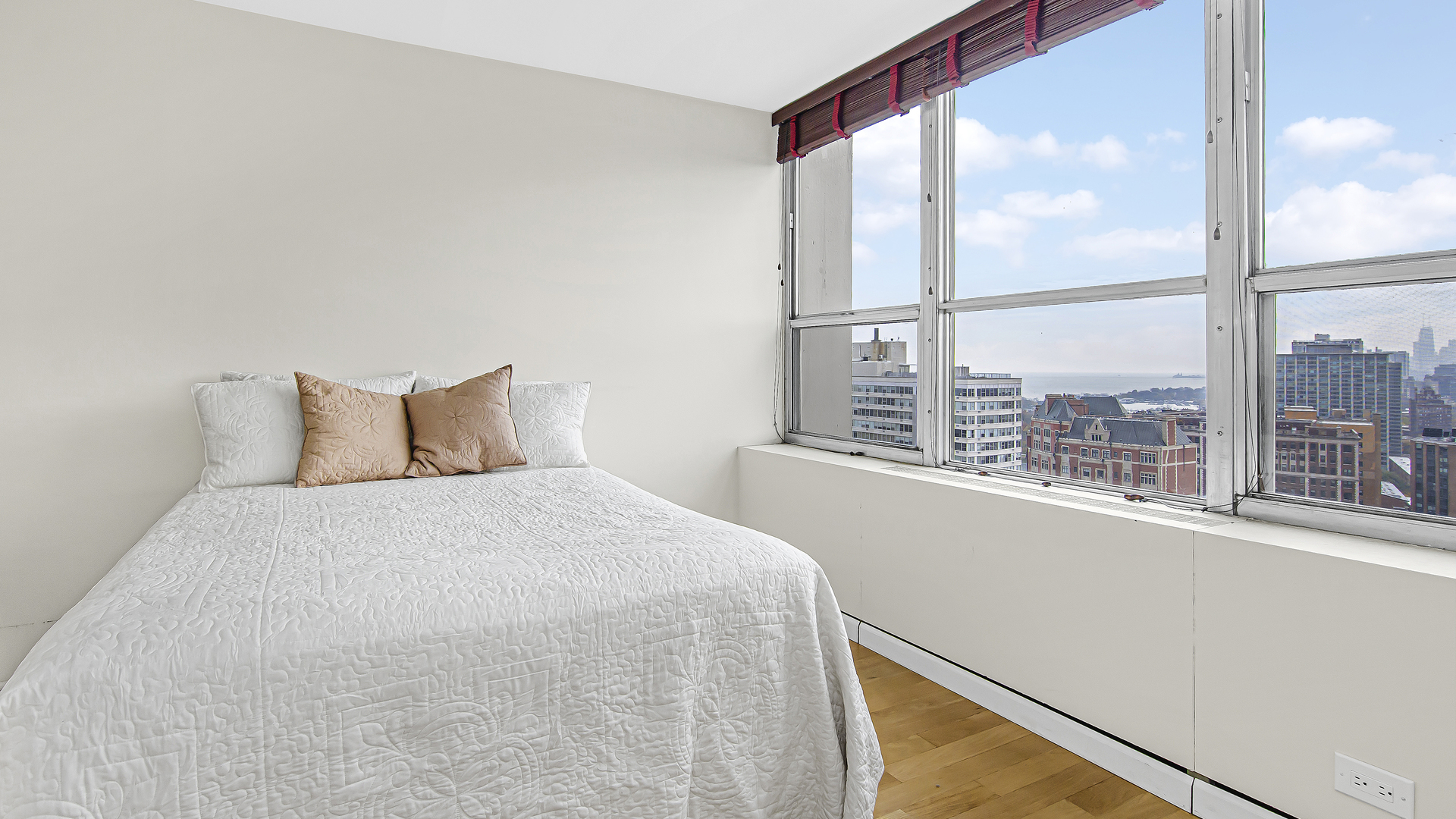 655 West Irving Park Road, Unit 2607 Chicago, IL 60613 - Photo 6 of 16 a bedroom with a large window and a bed