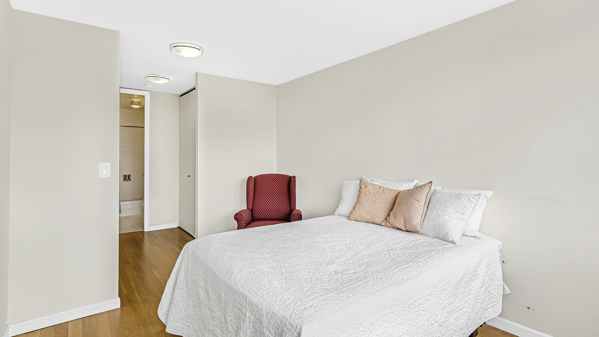 655 West Irving Park Road, Unit 2607 Chicago, IL 60613 - Photo 7 of 16 a bedroom with a bed and wooden floor