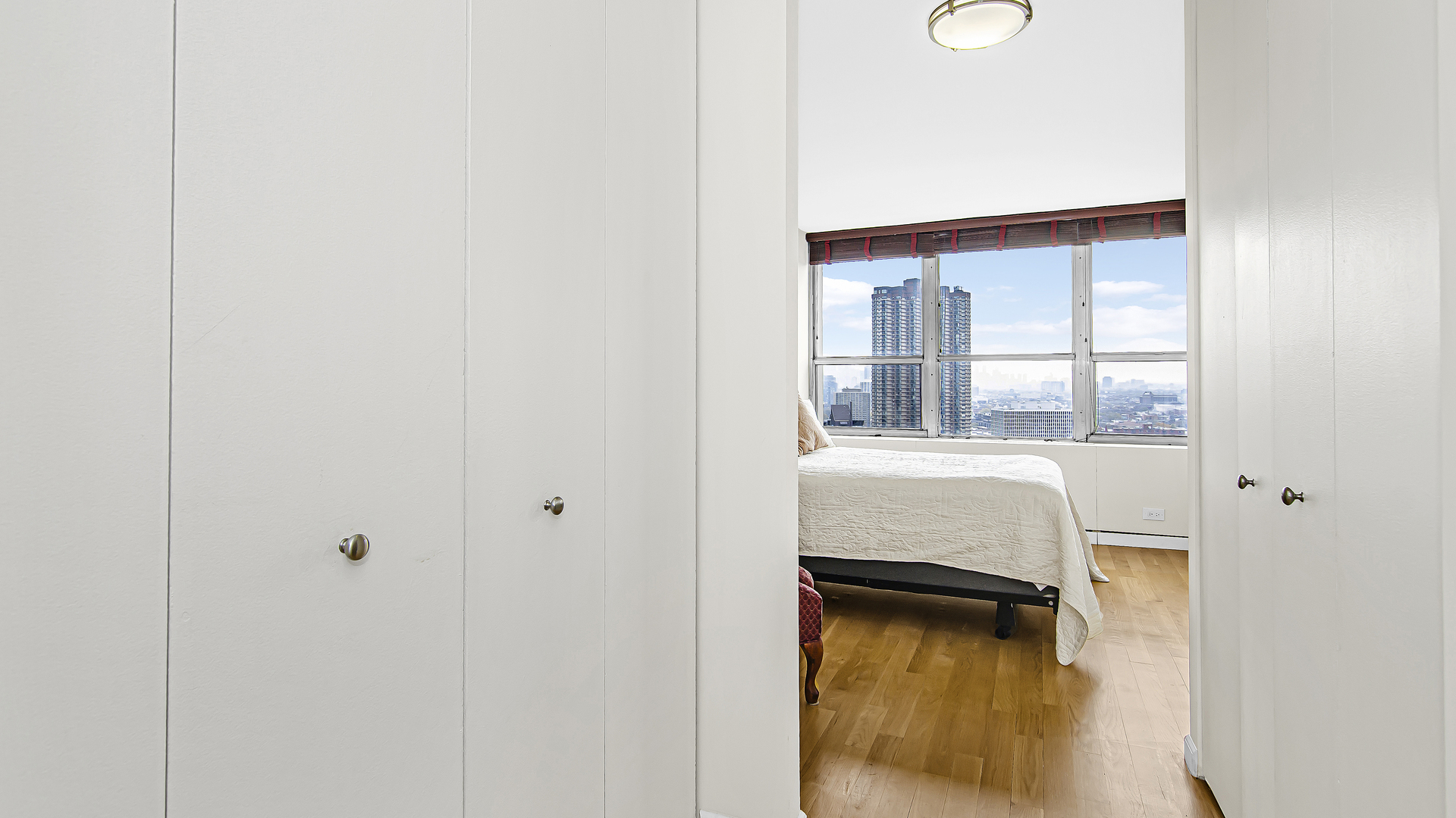 655 West Irving Park Road, Unit 2607 Chicago, IL 60613 - Photo 9 of 16 a bedroom with a bed and a window
