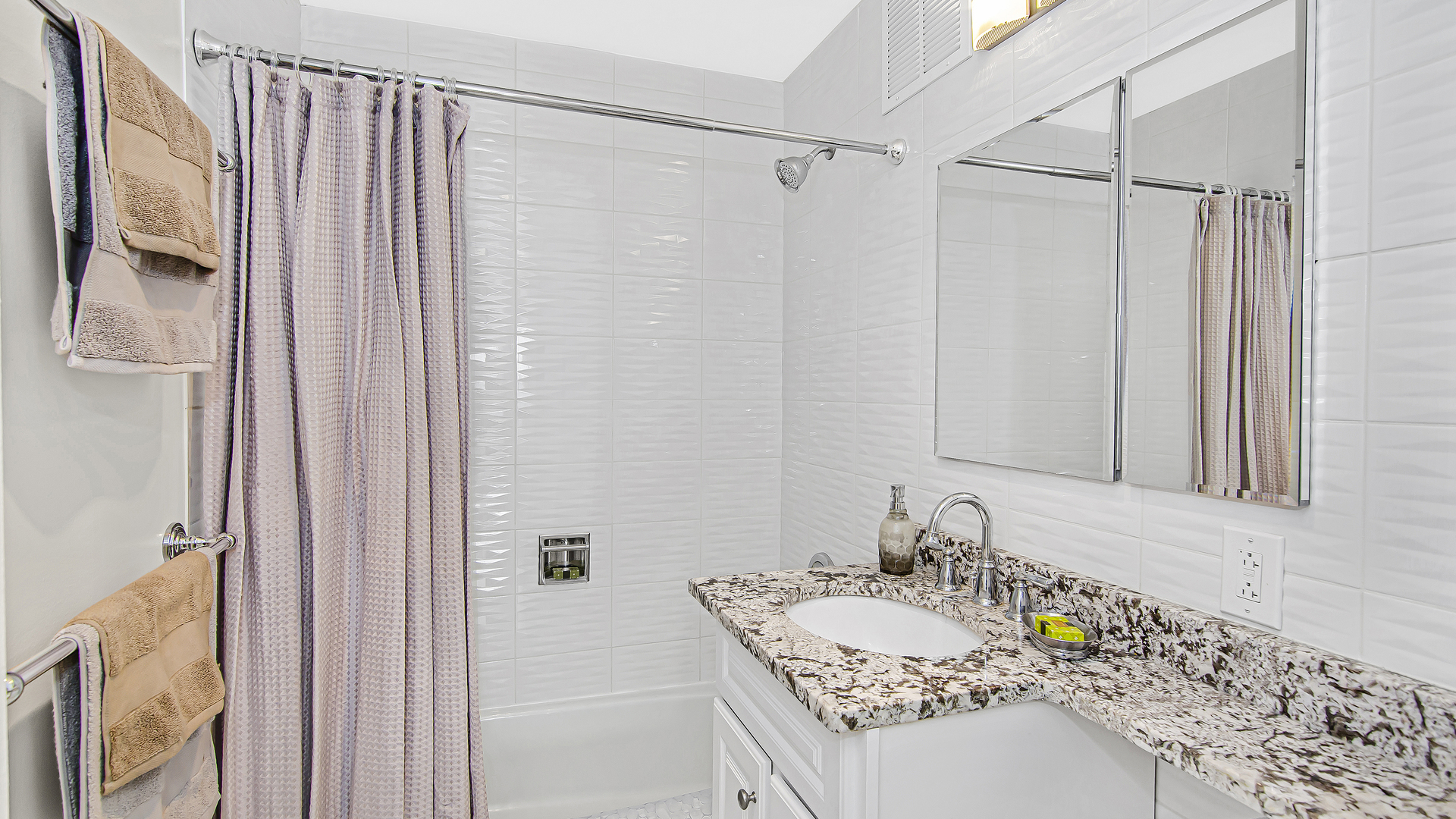 655 West Irving Park Road, Unit 2607 Chicago, IL 60613 - Photo 10 of 16 a bathroom with a granite countertop sink and a mirror