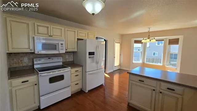 a kitchen with stainless steel appliances a stove a refrigerator and a sink