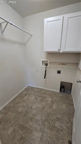 a view of a livingroom with wooden floor and stairs