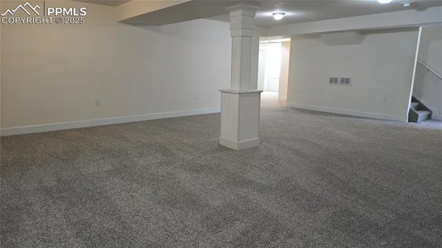 a view of an empty room with a closet