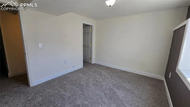 a view of a house with a small yard and wooden fence
