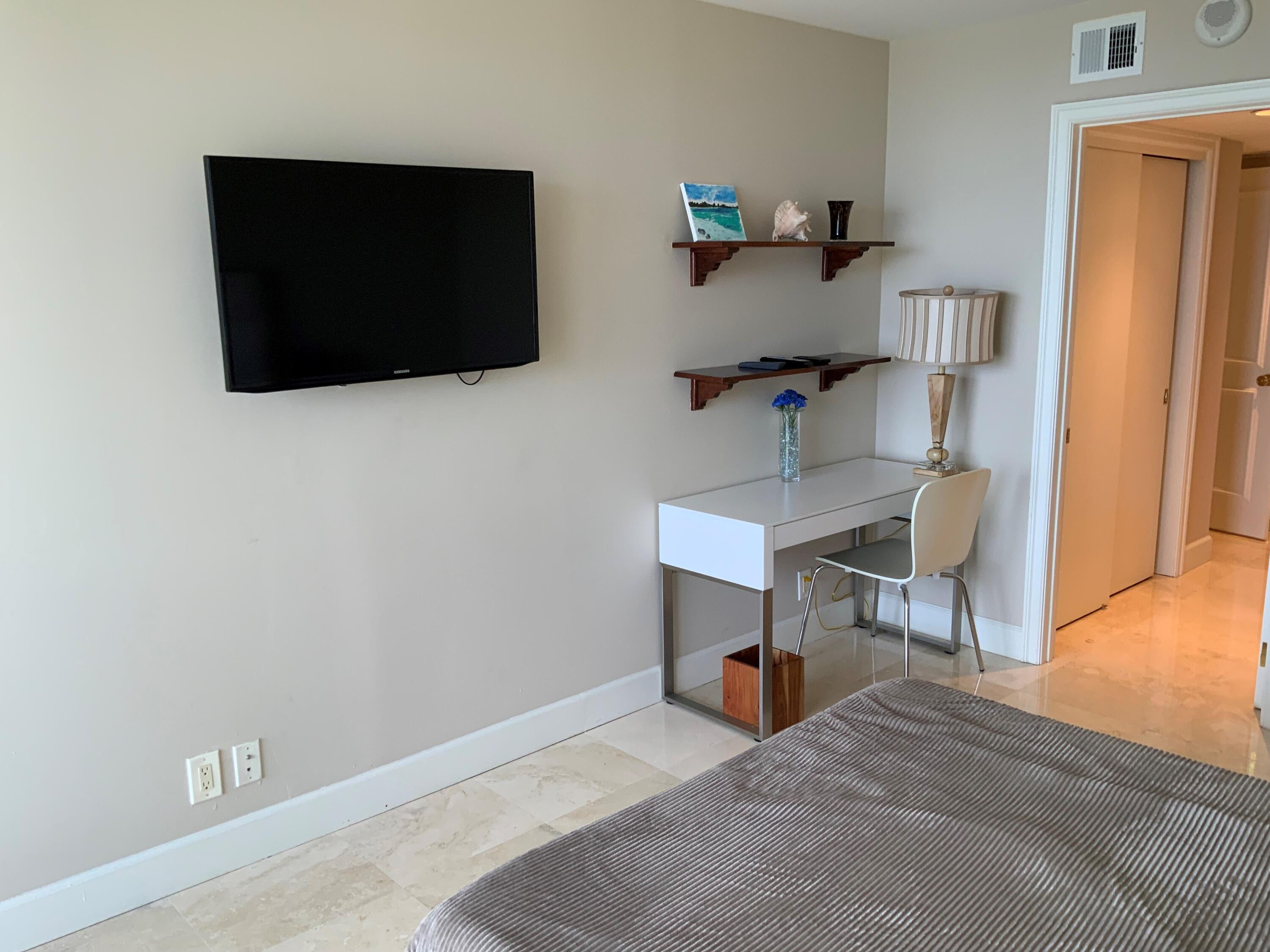 4201 North Ocean Boulevard, Unit 1705 Boca Raton, FL 33431 - Photo 15 of 37 a living room with furniture and a flat screen tv