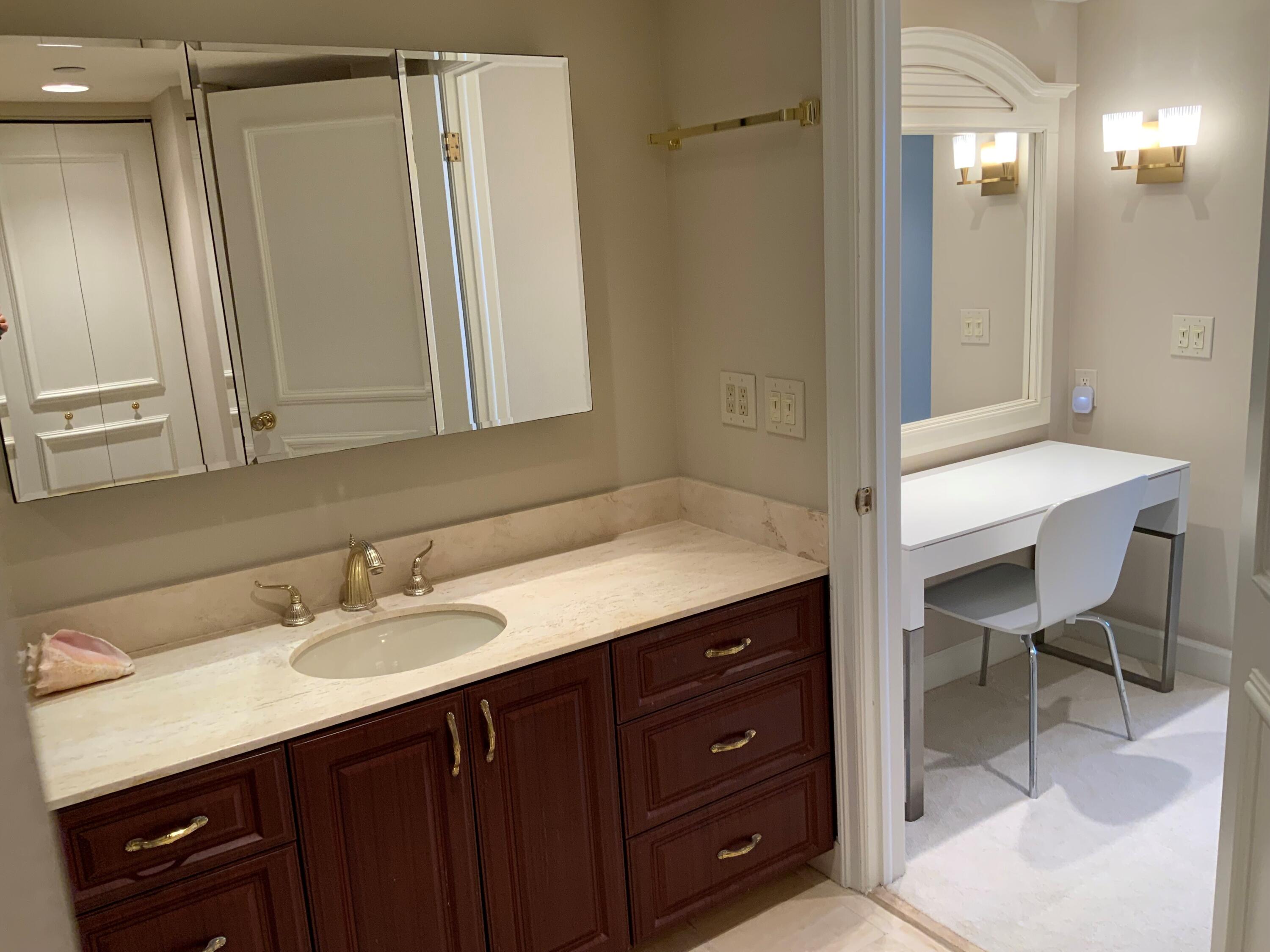 4201 North Ocean Boulevard, Unit 1705 Boca Raton, FL 33431 - Photo 21 of 37 a bathroom with a sink vanity granite tub and shower