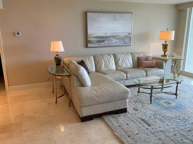 a living room with furniture and a lamp