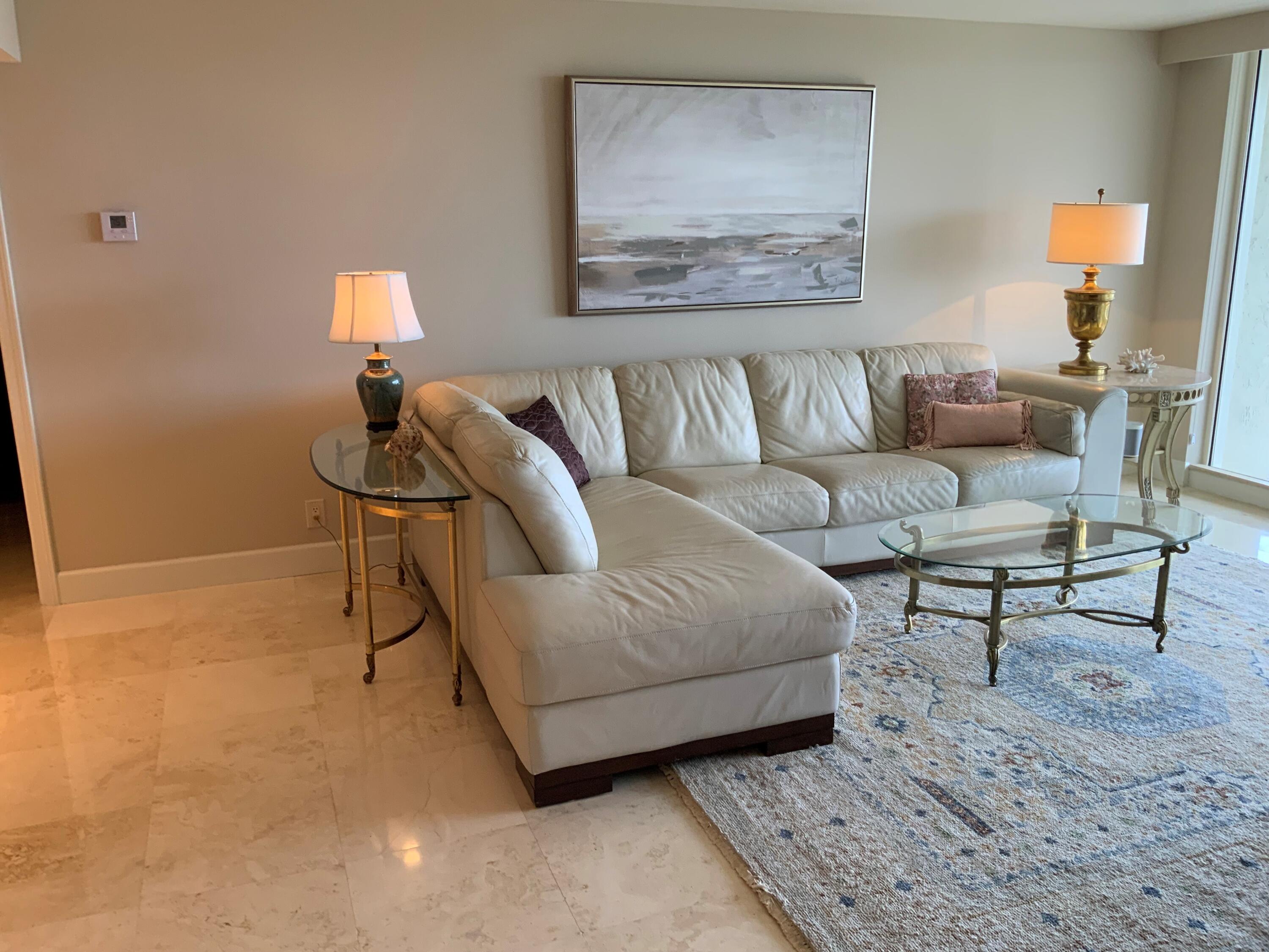 4201 North Ocean Boulevard, Unit 1705 Boca Raton, FL 33431 - Photo 9 of 37 a living room with furniture and a lamp