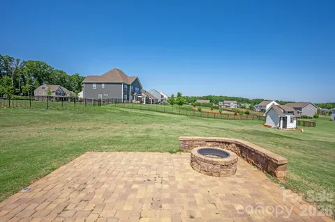a view of a garden with a house in the background